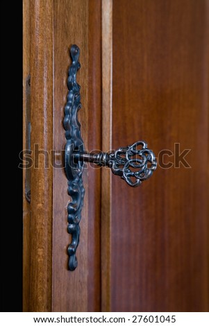 Old vintage key in a door lock