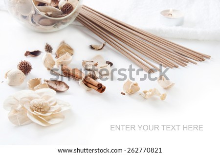 Still life with cinnamon, perfume sticks, aroma candle and ornamental dried flowers setting