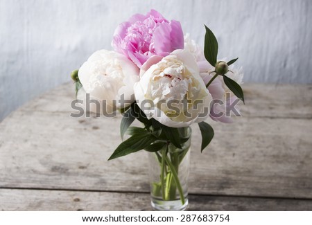 bouquet of peonies on a wooden background