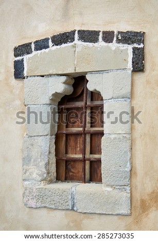 Boarded-up window with bars