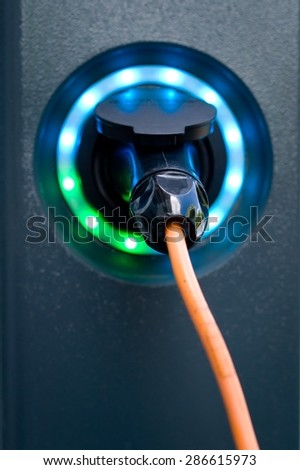 Socket for electrical car battery charger with load indicator lights, selective focus