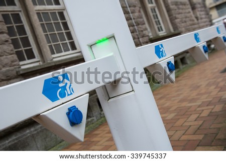 Socket for electric bike battery charger with green led lights, selective focus, angled view