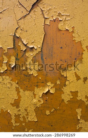 texture of cracked yellow paint on metal