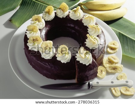 Round Chocolate Glazed Banana Cake in a Ring with Whipped Cream and Banana Chips Plus Steps