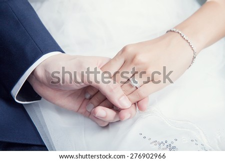 holding hand in wedding ceremony