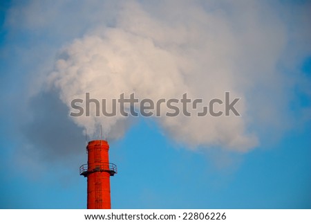 red factory chimney with smoke