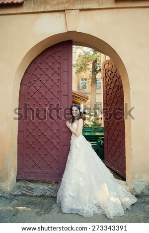 happy bride near the magnificent architecture