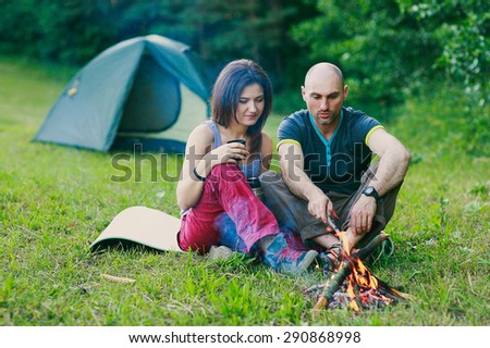 a couple in love is sitting at the fire