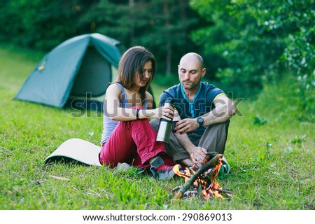 a couple in love is sitting at the fire