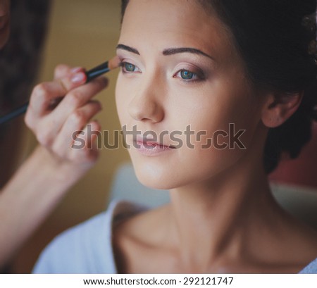 a girl is having her make up done