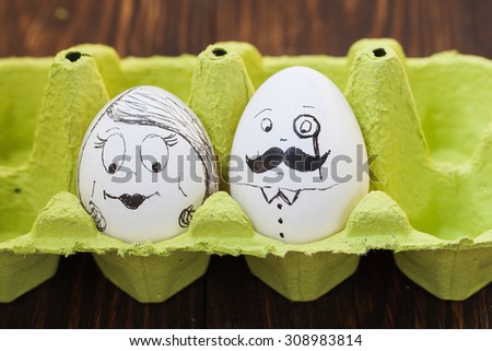 egg drawing, a couple drawn on eggs, man\'s face with mustache