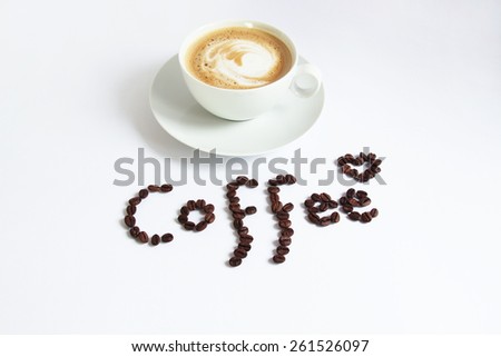 Hot coffee with a lettering made of coffee beans