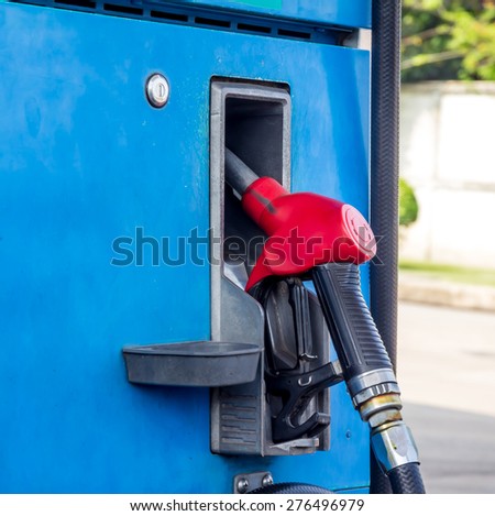 Fuel pump at a gas station for car.