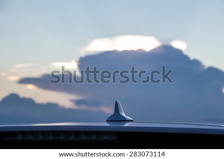 Car radio antenna and beautiful sky view.