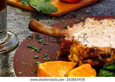 Cooked bone in port on a plate sitting on a granite counter top