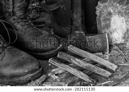 Still life work boots axe firewood kindling ash bucket black and white