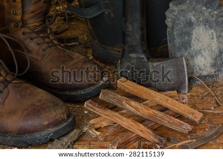 Still life work boots axe firewood kindling ash bucket