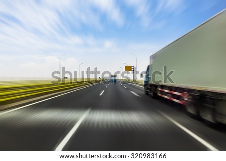 Truck on a fast express road, motion blur