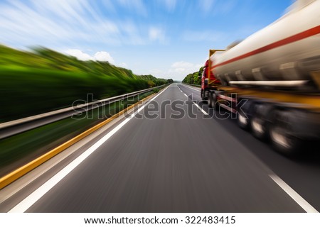 Motion blurred tanker truck on the highway. Chemical industry and pollution concept.