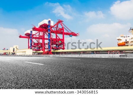 Highway bridge and truck transport container on the road to the port.