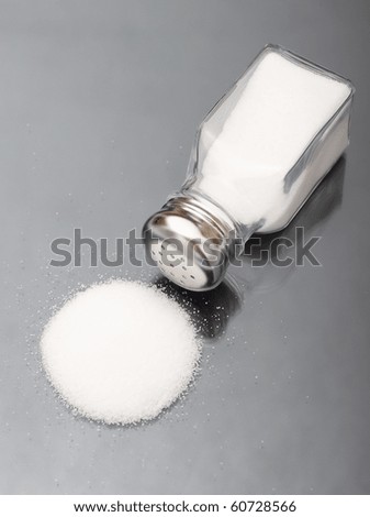 Spilled salt shaker with metal lid
