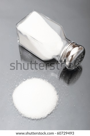 Spilled salt shaker with metal lid