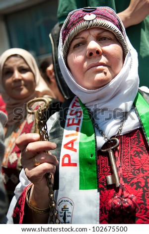 RAMALLAH, PALESTINIAN TERRITORIES - MAY 15: A Palestinian woman marches in Ramallah on Nakba Day, May 15, 2012, commemorating the expulsion of refugees from what became the state of Israel in 1948.