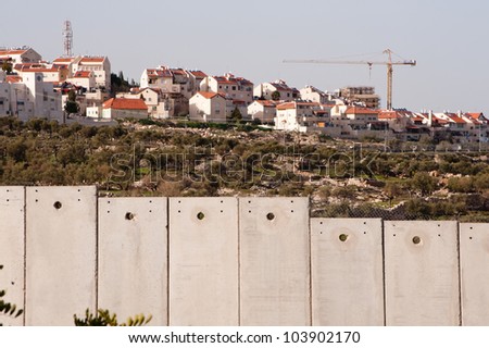 BETHLEHEM, PALESTINIAN TERRITORIES - MARCH 10: Construction continues in the Israeli settlement of Gilo, separated from the West Bank town of Bethlehem by the Israeli separation wall, March 10, 2012.