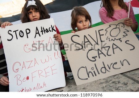 BETHLEHEM, PALESTINIAN TERRITORIES - NOV. 15: Unidentified Palestinian children hold signs protesting Israeli military strikes on Gaza, during a vigil in Bethlehem\'s Manger Square, November 15, 2012.