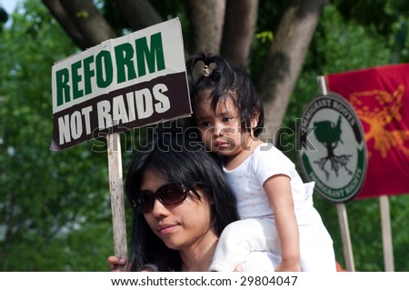 WASHINGTON, DC - MAY 1: Lucy Artiga and her 18-month-old daughter Katia march to the White House to call for immigration reform and an end to workplace raids May 1, 2009 in Washington, DC.