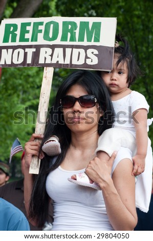 WASHINGTON, DC - MAY 1: Lucy Artiga and her 18-month-old daughter Katia march to the White House to call for immigration reform and an end to workplace raids May 1, 2009 in Washington, DC.