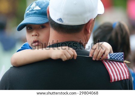 WASHINGTON, DC - MAY 1: Nelson Navidad holds his son Nelson Jose, 4, at a rally of immigrants and supporters calling for legal reforms and an end to workplace raids May 1, 2009 in Washington, DC.
