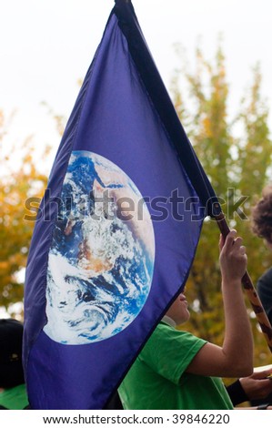 WASHINGTON, DC - OCTOBER 24: Environmental activist flies a flag with the planet earth during the International Day of Climate Action on October 24, 2009 in Washington, DC