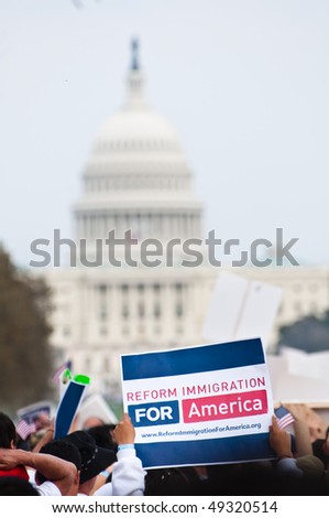 WASHINGTON, DC - MARCH 21: The U.S. Capitol building in the distance, some 200,000 immigrants\' rights activists flood the National Mall to demand comprehensive immigration reform on March 21, 2010 in Washington DC.