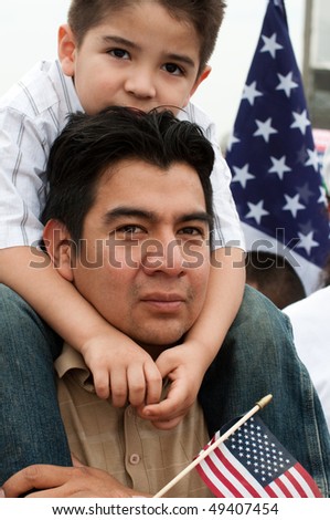 WASHINGTON, DC - MARCH 21: Daniel Rogel and son Daniel Rogel Jr. (4) of Silver Spring MD stand with some 200,000 immigrants\' rights activists on the National Mall on March 21, 2010 in Washington, DC.