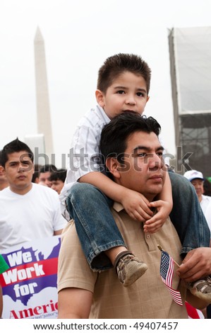 WASHINGTON, DC - MARCH 21: Daniel Rogel and son Daniel Rogel Jr. (4) of Silver Spring MD stand with some 200,000 immigrants' rights activists on the National Mall on March 21, 2010 in Washington, DC.