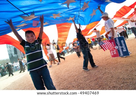 WASHINGTON, DC - MARCH 21:  Marchers hold a giant American flag as some 200,000 immigrants\' rights activists flood the National Mall  on March 21, 2010 in Washington, DC.