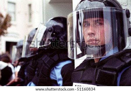 WASHINGTON, DC - SEPT 27: Police in full riot gear and batons guard Gap stores during anti-sweatshop protests on Sept. 27, 2002 in Washington, DC.