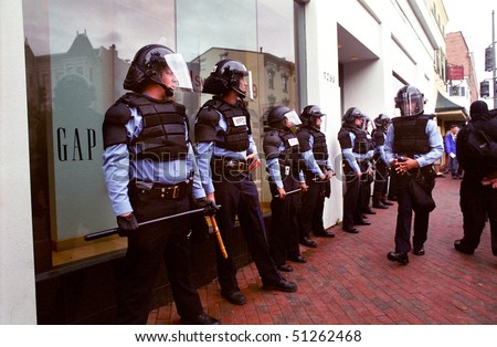 WASHINGTON, DC - SEPT 27: Police in full riot gear and batons guard Gap stores during anti-sweatshop protests on Sept. 27, 2002 in Washington, DC