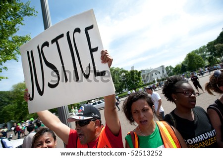 WASHINGTON, DC - MAY 1: An immigration reform activist holds a sign reading 