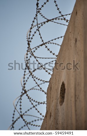 Coils of razor wire top the Israeli separation barrier in the Palestinian neighborhood of Al-Ram, now cut off from the rest of Arab East Jerusalem.