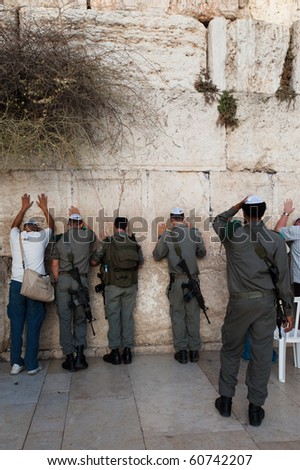 JERUSALEM - SEPTEMBER 7: Israeli security forces armed with assault rifles pray at the Western Wall in Jerusalem on September 7, 2010. Status of such holy sites is a major issue in peace negotiations.