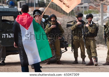AL-WALAJA - NOVEMBER 13: Palestinian activists confront Israeli soldiers in a protest against the Israeli separation wall in Al-Walaja on Nov. 13, 2010.