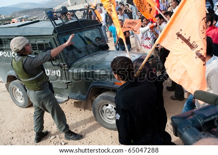 AL-WALAJA - NOVEMBER 13: Palestinian activists confront Israeli soldiers in a protest against the Israeli separation wall on Nov. 13, 2010 in Al-Walaja.