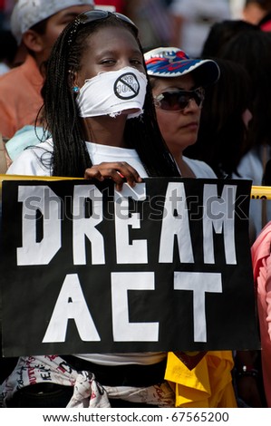 WASHINGTON, DC - MAY 1: An immigration reform activist holds a sign reading \