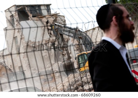 EAST JERUSALEM - JANUARY 9: An orthodox Jew stands next to the demolition of buildings in the East Jerusalem neighborhood of Sheikh Jarrah to make way for Jewish settlements on Jan. 9, 2011 in East Jerusalem.