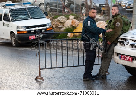 EAST JERUSALEM - FEBRUARY 11: Unidentified Israeli police set up checkpoints to guard Jewish settlers who've seized Palestinian homes in the Sheikh Jarrah neighborhood of East Jerusalem on Feb. 11, 2011.