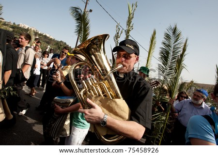 JERUSALEM - APRIL 17: With various musical instruments, Christians from all over the world commemorate Jesus\' journey from the Mount of Olives to Jerusalem on Palm Sunday, April 17, 2011 in Jerusalem.