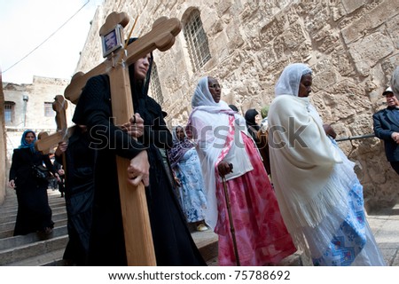 JERUSALEM - APRIL 22: Christian pilgrims commemorate the path Jesus carried his cross on the day of his crucifixion along the Via Dolorosa in Jerusalem on Good Friday, April 22, 2011.
