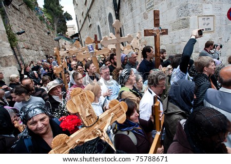 JERUSALEM - APRIL 22: Orthodox Christian pilgrims commemorate the path Jesus carried his cross on the day of his crucifixion along the Via Dolorosa in Jerusalem on Good Friday, April 22, 2011.